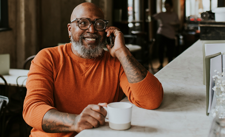 A smiling man on the phone